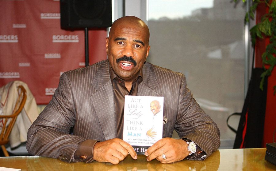 Steve Harvey poses with his book, 
