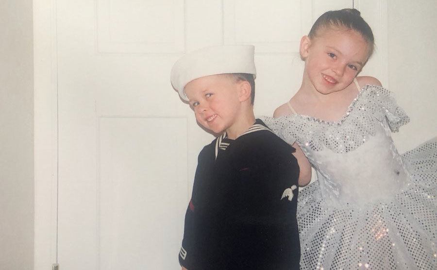 Sydney and her brother pose together in costumes as little kids. 