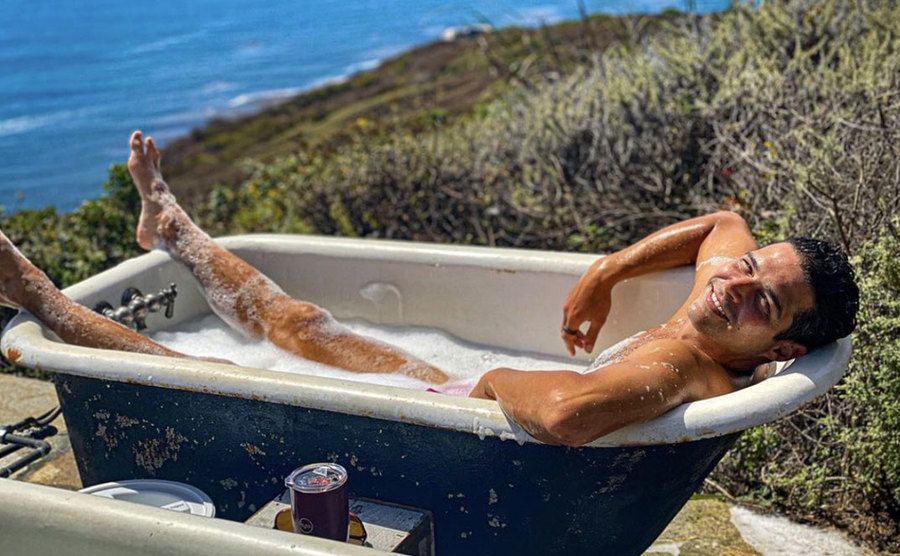 Wells Adams enjoys a soak in an outdoor tub. 