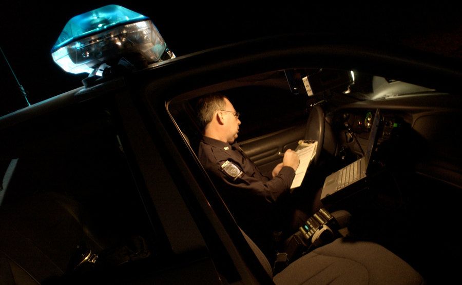 An officer attends a call on his vehicle.