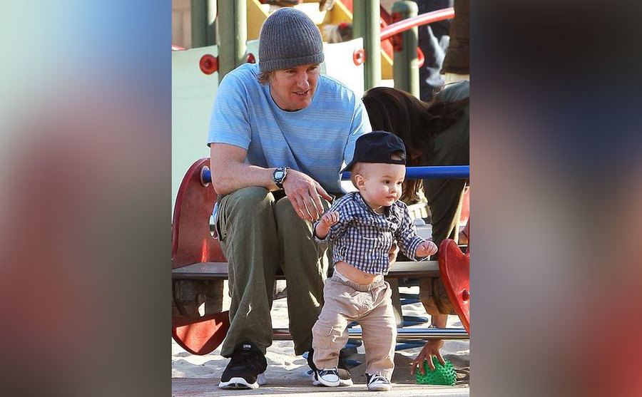 Owen Wilson plays with his son at the park. 