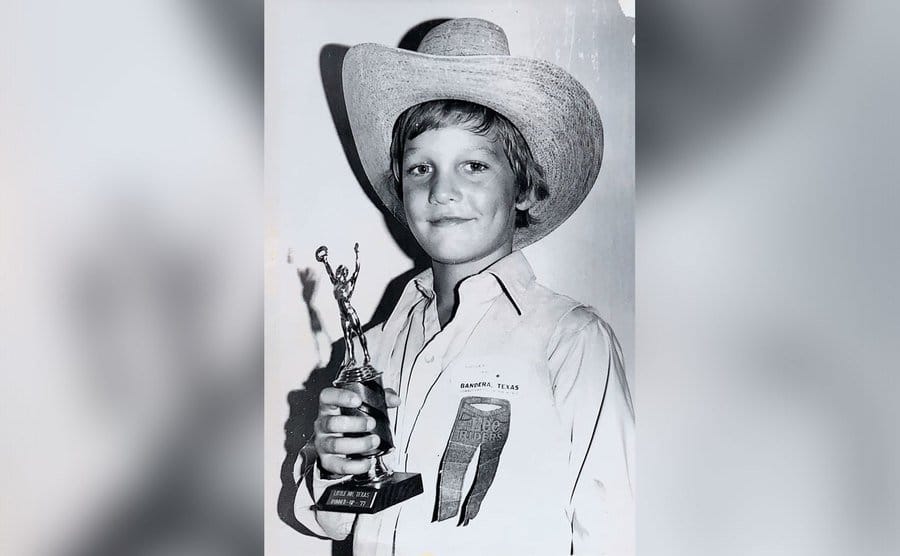 Matthew McConaughey at age 8 holds up a trophy he won. 