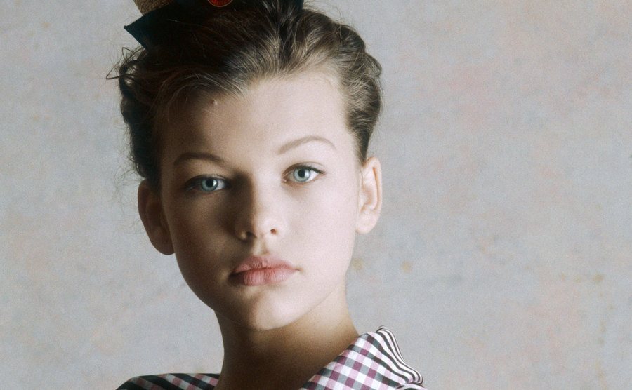 A modeling studio portrait of a young Milla Jovovich.