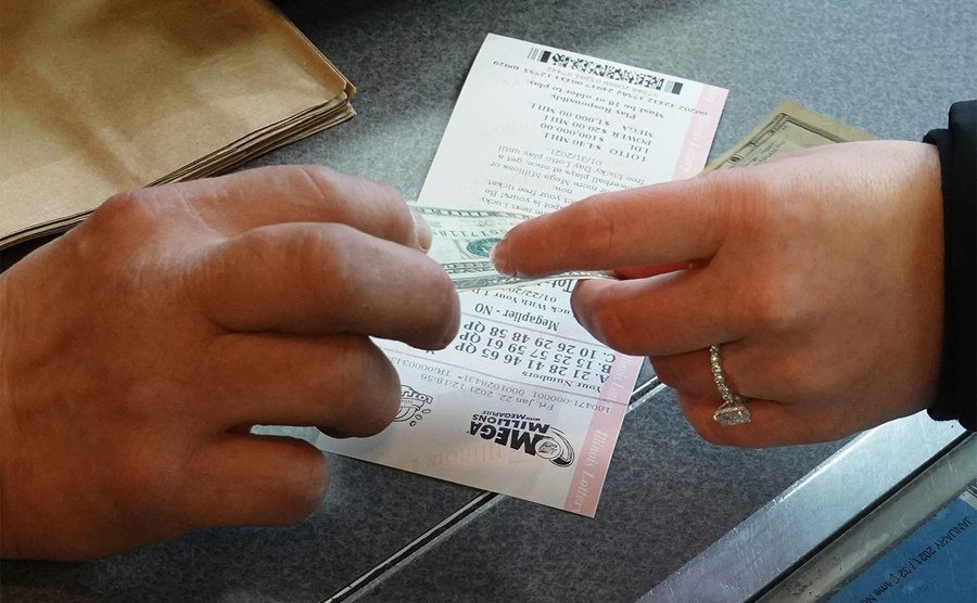 A customer purchases a Mega Millions lottery ticket. 