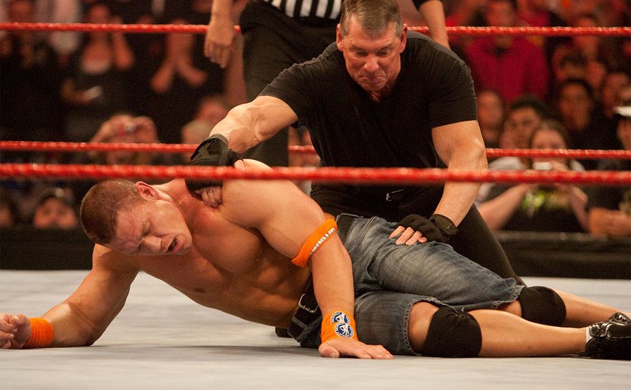 Mr. McMahon tries to pin John Cena during WWE’s Monday Night Raw. 
