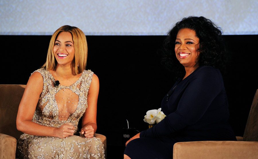 Beyoncé and Oprah Winfrey speak on stage.