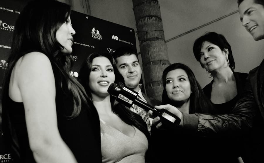 A dated picture of the Kardashians talking to the press.