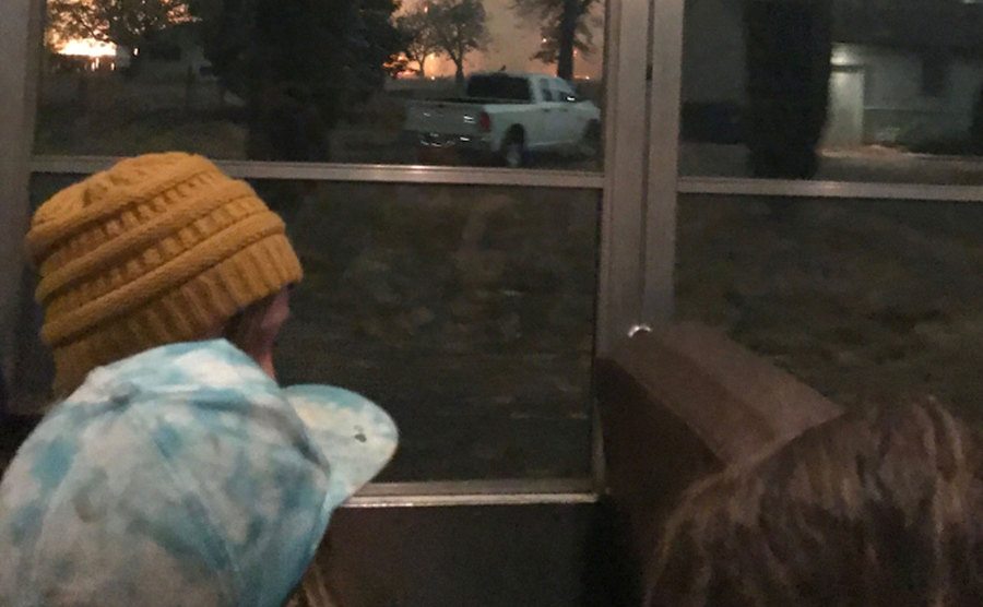 A photo of the kids looking through the bus windows.