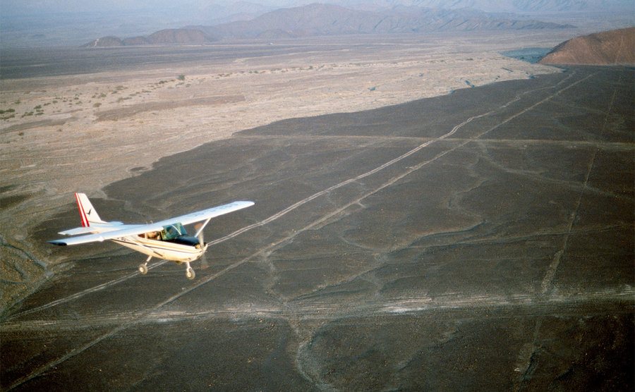 Tourists fly in a small plane over the Nazca Lines of Peru.