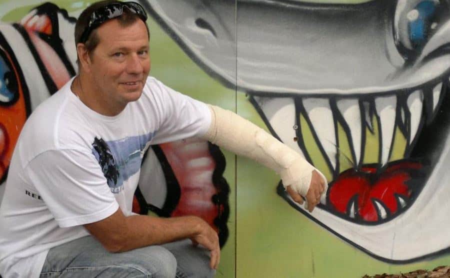 Pearson poses for a picture next to a shark mural painting.