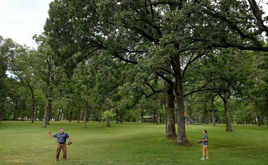 An image of Dan playing a game of catch in a park.