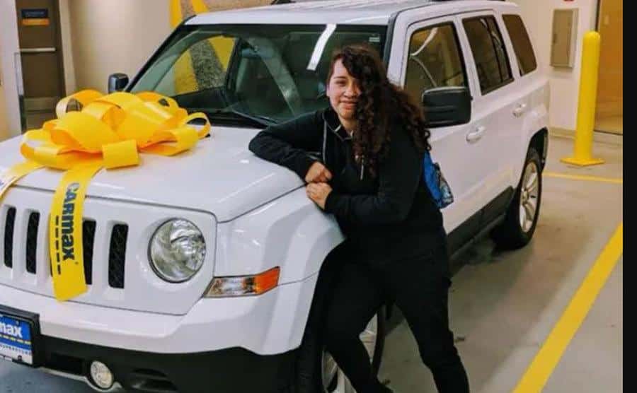 A dated picture of Hernandez posing next to her white 2011 Jeep.