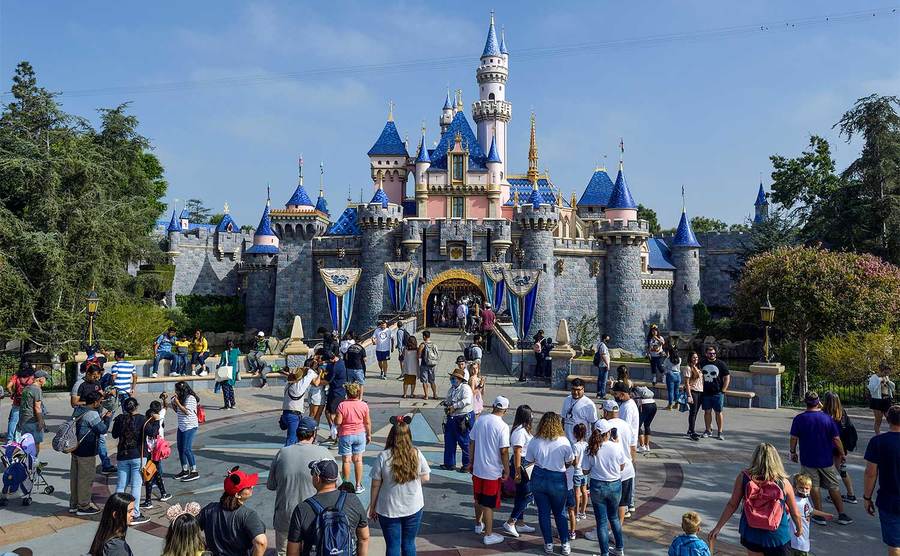 Visitors to Disneyland in front of Sleeping Beauty Castle. 