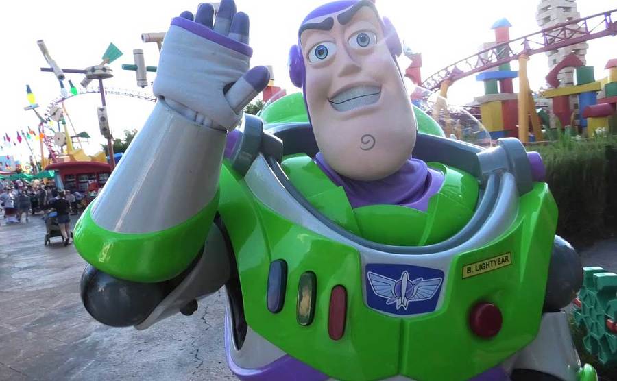 Buzz Lightyear waves hello at park goers. 