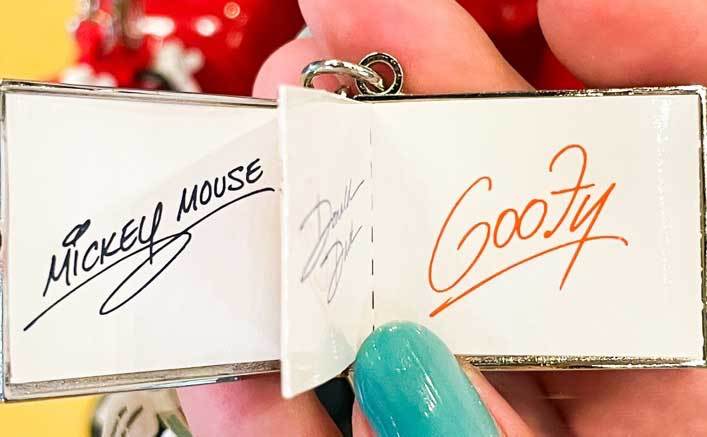 A small autograph book filled with character signatures 