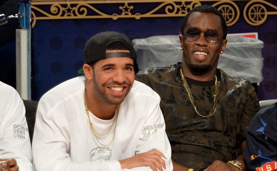 Drake and P. Diddy attend a basketball game. 