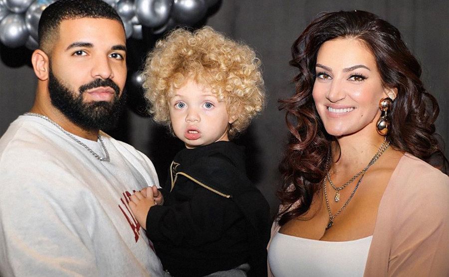 Drake, his son, and Sophie Brussaux pose together. 