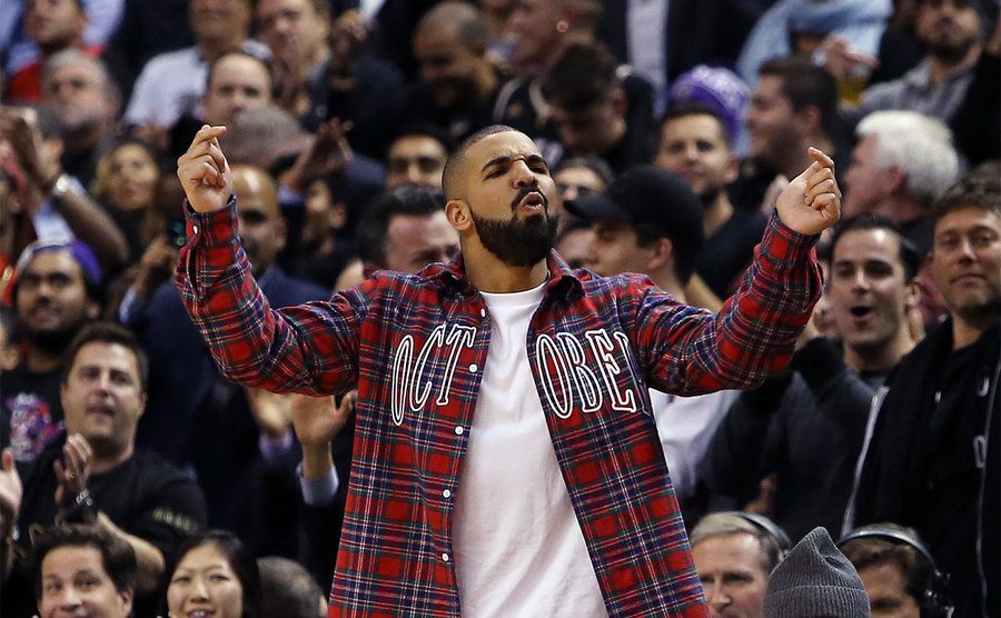 Drake yells from the sidelines of a basketball game. 