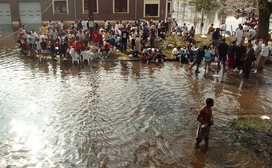 Survivors rescued from their flooded Lower Ninth Ward houses wait for a pick-up. 