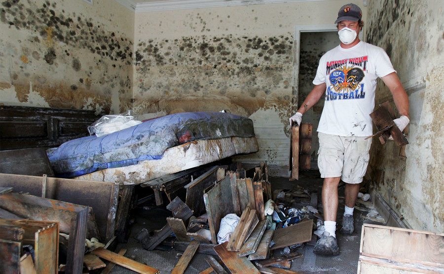 A man removes furniture and debris out of a friend’s house. 