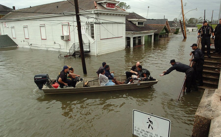 New Orleans police bring people ashore from the rescue boats. 